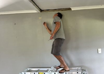 Painter at work on Farm21 Ecoresort walls