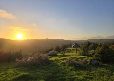 Sunset behind two-storey house at Farm21