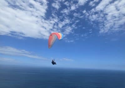Paragliders flying together over Indian Oceon